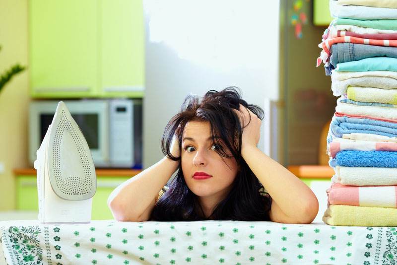 Woman tired after ironing